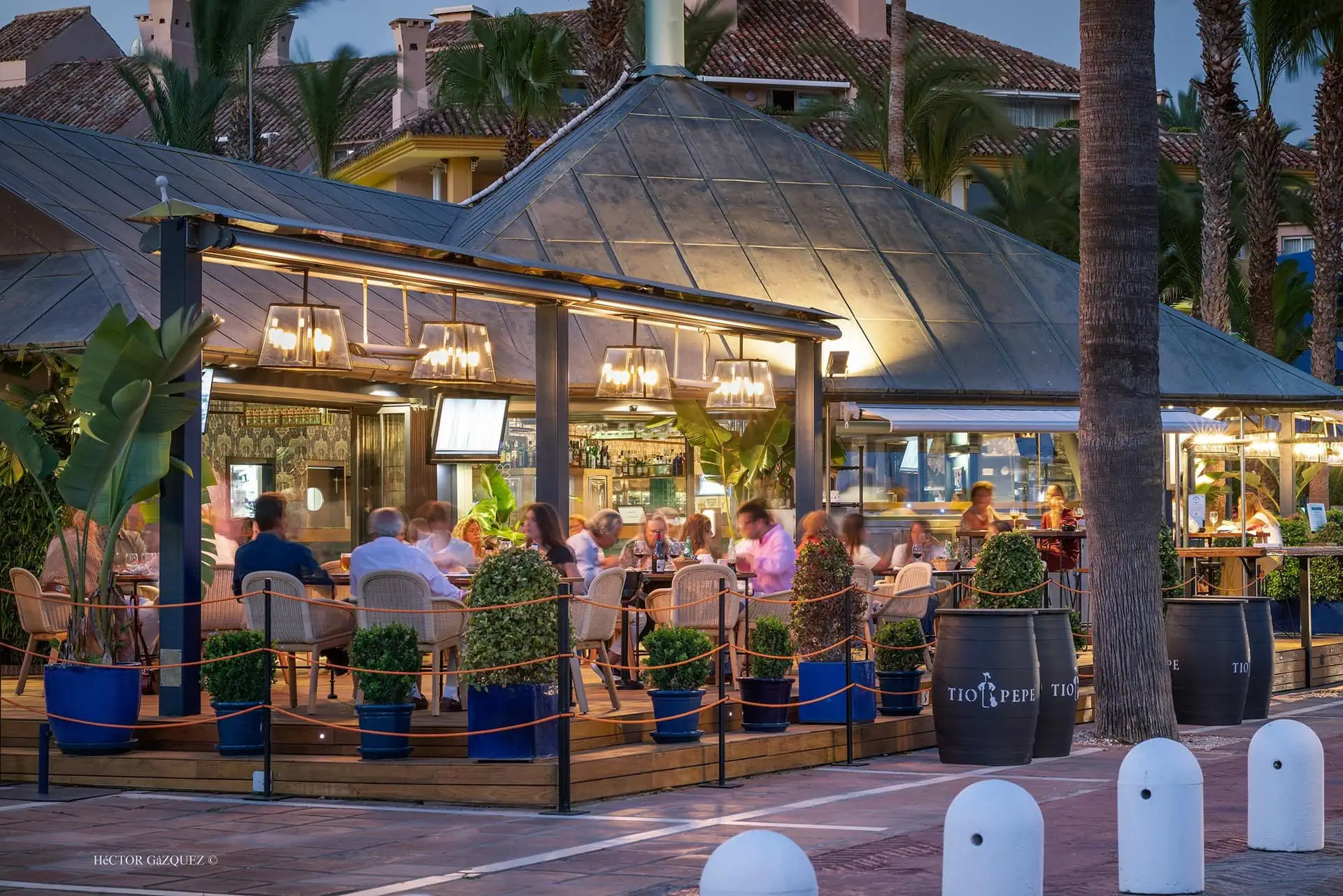 Evening terrace restaurant with people dining in Sotogrande marina