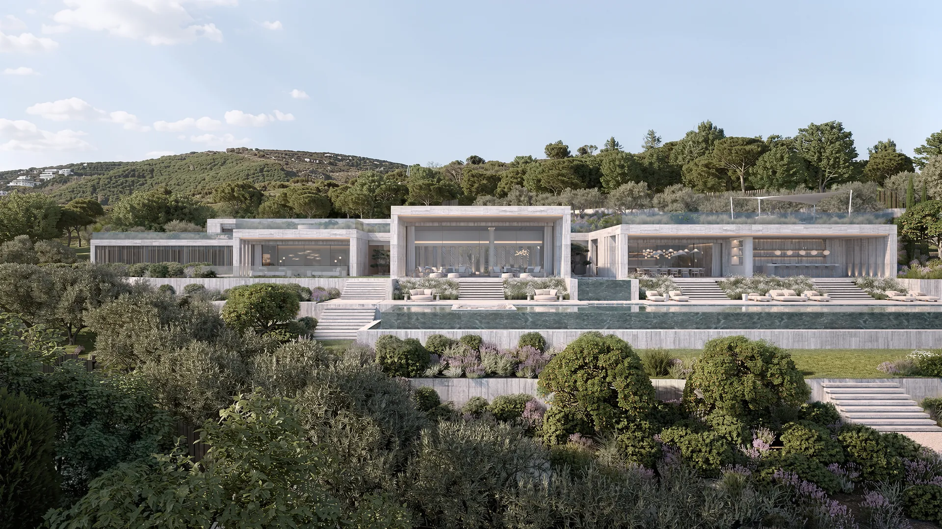 Lujosa villa moderna rodeada de exuberante vegetación y colinas. La vivienda cuenta con amplios ventanales, jardines en terrazas y un ambiente tranquilo.